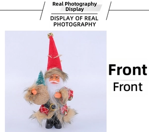 Front view detail of a Santa Claus plush figurine holding a small pine tree gift bag