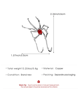 Detailed size chart of a silver spider ear cuff featuring a red gemstone inlay