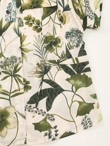 Detail of floral shirt and pants with green leaf print and adjustable waist drawstring