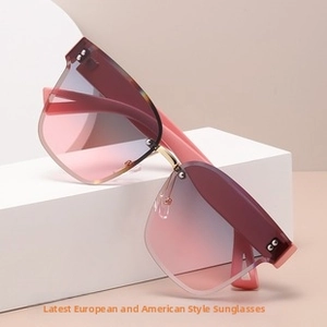 Close-up of rimless butterfly sunglasses with pink-blue gradient lenses and metal bridge