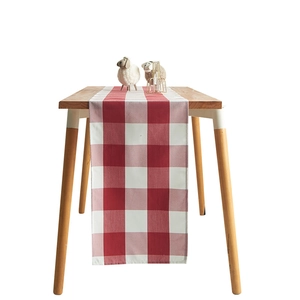 Nordic red and white plaid table runner made of polyester cotton on a wooden table