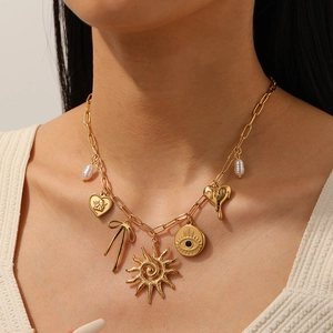 Gold stainless steel paperclip necklace featuring evil eye, sun, and heart charms