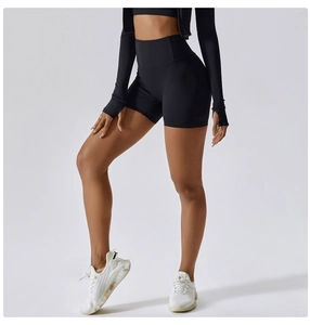 Close-up of black high-waisted fitness set showing premium matte compression fabric detail