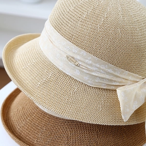 Elegant Hepburn style straw sun hat with floral bow tie in beige and coffee brown colors