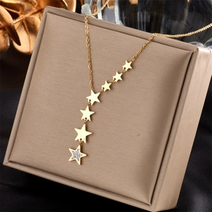 Chic gold titanium steel Y-necklace with star pendants displayed on a jewelry box