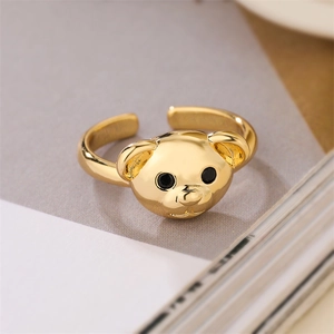 Close-up of golden bear ring with black eyes and adjustable open band design