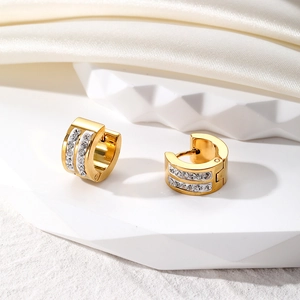 Close-up of golden stainless steel hoop earrings featuring double rows of white cubic zirconia