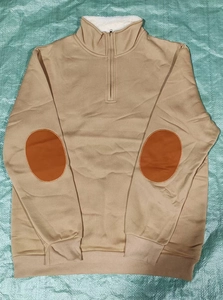Detail of half-zip khaki fleece hoodie featuring orange elbow patches and ribbed cuffs