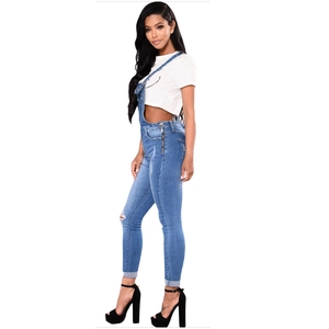 Women's light blue ripped denim overalls with slim fit legs and side zipper detail