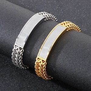 Detail of silver and gold titanium steel Cuban chain bracelets with carbon fiber inlay
