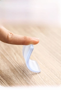 Macro shot showing high flexibility of transparent soft silicone furniture leveling wedges