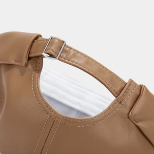 Detailed macro view of the brown PU leather texture and adjustable metal buckle on back