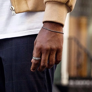 Silver twisted rope ring and matching chain bracelet set for men in urban lifestyle shot