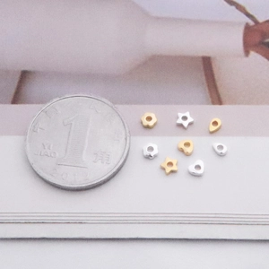 S925 sterling silver DIY beads in star and heart shapes compared to a small coin