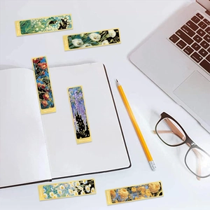 Close-up of floral oil painting bookmarks with gold borders on a clean desk