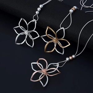 Three minimalist hollow flower pendant necklaces with snake chains in gold and silver finish