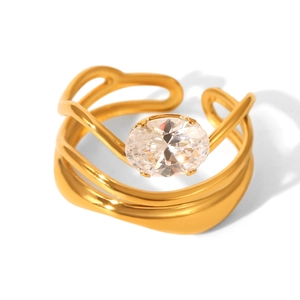 Detailed view of a gold geometric ring featuring an oval-cut cubic zirconia stone