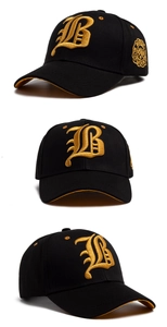 Detail of 3D gold letter B embroidery and side badge on black cotton baseball cap