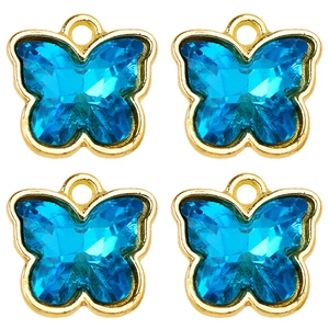 Macro view of four sky blue crystal butterfly pendants with golden metal edges