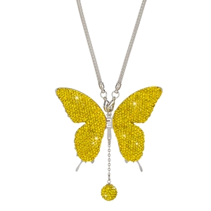 Macro shot of silver metal butterfly car pendant with yellow crystals and a small NU charm