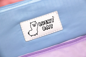 Detailansicht der wasserfesten Nylon-Federtasche mit Alpaka-Patch und Lucky Day Text