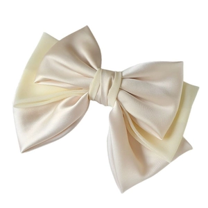 Elegant cream satin and mesh bow hair clip with a layered French luxury aesthetic