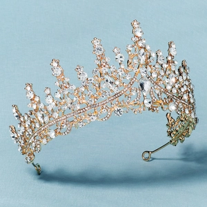 Detailed side view of luxury gold bridal crown with sparkling crystals and hollow design