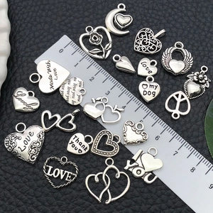 Assorted vintage silver hollow heart and floral alloy pendants with measurement ruler