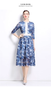 Detail of blue and white floral water-soluble lace dress with intricate hollow patterns