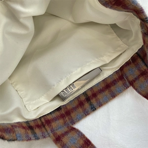 Detail view of the vintage plaid tote bag interior showing the inner pocket and lining