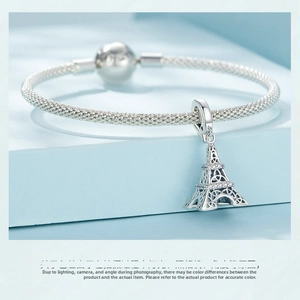 Detail view of S925 sterling silver Eiffel Tower charm on woven mesh bracelet with crystals