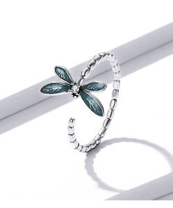 Detailed macro shot of 925 silver dragonfly ring with blue enamel wings and zircon