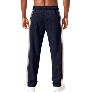 Detail view showing textured corduroy fabric and side stripes on navy jogger pants