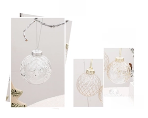 Detailed view of 8cm transparent Christmas balls with white snowflake and star patterns
