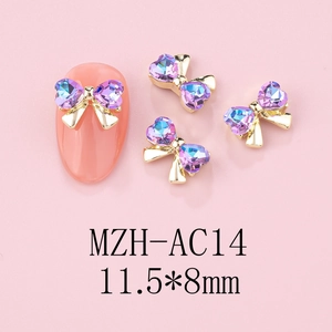 Detailed view of 3D bowknot nail charms with heart-shaped crystals on pink nail