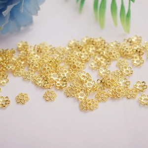 Macro shot of 14K gold plated hollow floral spacer beads for DIY jewelry making