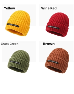 Detail of four color options showing ribbed knit texture and stylish patch on beanie