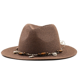 Brown woven Panama straw hat with shell and wood bead decorations for summer beach sun protection