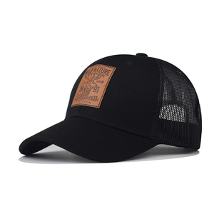 Black trucker hat with mesh back and brown leather patch featuring a deer logo design