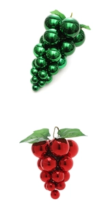 Detail of grape-shaped Christmas ball ornaments in shiny green and wine red finishes
