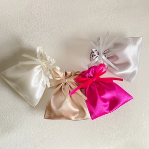 Satin drawstring gift bags in white, gold, pink and silver silk fabric texture