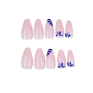 Long almond press-on nails with light pink base and blue floral patterns on white background
