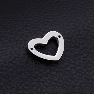 Detailed view of heart-shaped stainless steel pendant with dual side holes for DIY jewelry