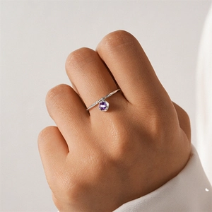 Macro detail of S925 sterling silver ring featuring a round purple zircon stone pendant