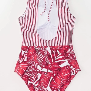 Halter neck one-piece swimsuit featuring red stripes and tropical leaf print pattern