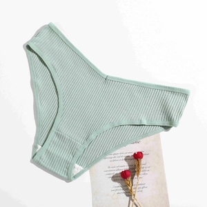 Detail of light green ribbed cotton panties with V-shape waist and breathable fabric texture
