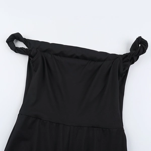 Detail of twisted off-the-shoulder neckline on a black slim-fit fashion jumpsuit