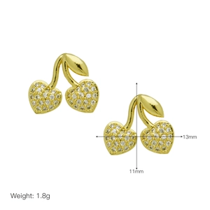 Detail shot of cherry-shaped gold earrings with heart-shaped white zircon and size specs