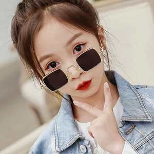 Retro square metal sunglasses for kids with gold frames and dark lenses on model