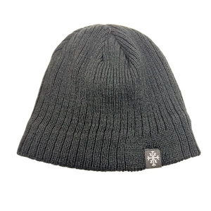 Close-up of black knitted beanie with grey snowflake woven label on white background